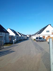 a row of houses in a parking lot at Willa Nicola in Trzęsacz