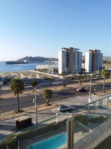 a view of a city with a parking lot and the ocean at Departamento Frente al Mar in Coquimbo