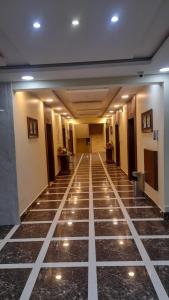 a hallway of a hotel with lights on the floor at شقق مساكن السمو المخدومة in Ad Dawādimī