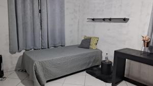 a bedroom with a bed and a tv in it at Loft Vista de Vila Velha in Vila Velha