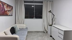 a living room with a couch and a window at Loft Vista de Vila Velha in Vila Velha