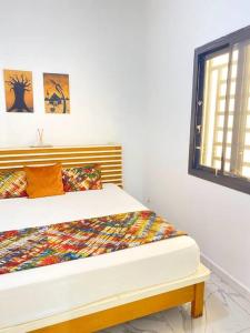 a bedroom with a bed in a room with a window at Villa Mamath 