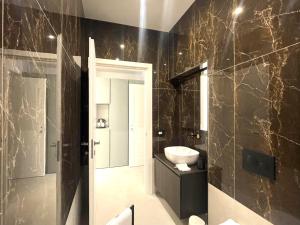 a bathroom with a sink and a toilet in it at B and G San Babila luxury in the heart of Milano - Design district in Milan