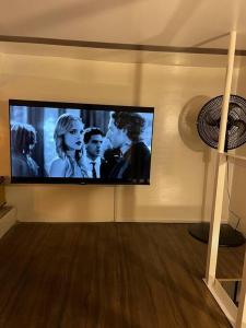 a flat screen tv on a wall in a living room at Casa colonial Rosa San Antonio in Cali