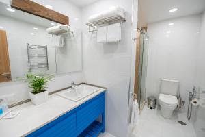 a bathroom with a sink and a toilet and a mirror at Seagull Hotel Batumi in Batumi