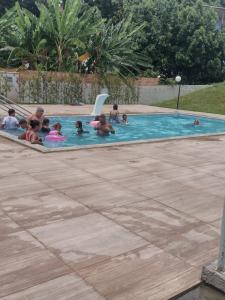 un groupe de personnes jouant dans une piscine dans l'établissement Residencial Versalhes Aluguel barato AP rua santa Terezinha 213, santa cruz , Vespasiano MG, à Vespasiano