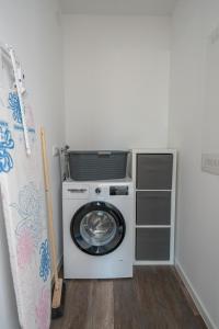 a washing machine in a laundry room with a washer at Cozy City Dream Apartment mit Terrasse und Parkplatz - 90m² in Dresden