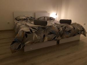 a bed with two pillows on it in a room at Hradňanka Food&Beer in Predmier