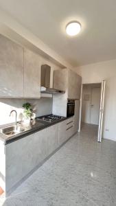 a large kitchen with a sink and a stove at Dream & Relax in San Donato Milanese