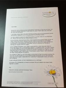 a page of a document with a flower on it at Landhotel Grönenbach in Bad Grönenbach