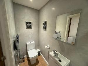 a bathroom with a white toilet and a sink at LT Apartment 52 - Free Street Parking in Leicester