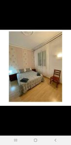 ein Schlafzimmer mit einem Bett und einem Stuhl darin in der Unterkunft Barcelona Centric in Barcelona