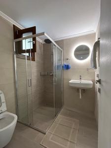 a bathroom with a shower and a sink at Oceanis apartment in Symi