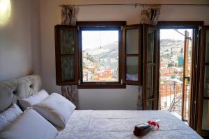 a living room with a couch and two windows at Oceanis apartment in Symi