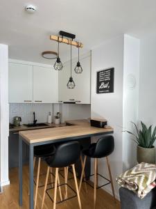 a kitchen with a table and two bar stools at Staza Ski Apartment in Jahorina