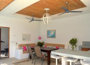 a dining room with a table and chairs at Luxury Beachfront Oasis - Hermosa Palms 50 in Playa Hermosa
