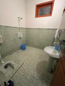 a bathroom with a sink and a toilet at Airport Hotel Bed & Rest in Karachi