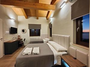 a bedroom with a large bed with towels on it at B&B Casa MariLù in Fuscaldo