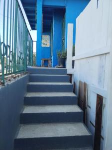 a staircase leading to a blue building with a bench at Monchita's Ensenada Baja, apartments for rent. in Ensenada
