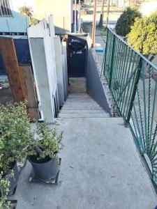 a stairway leading up to a house with a trash can at Monchita's Ensenada Baja, apartments for rent. in Ensenada