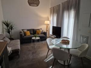 salon z kanapą, stołem i krzesłami w obiekcie Atico en Puerta Osario w Sewilli +50 zdjęć