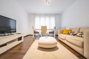 a living room with a couch and a table at Joli appartement Le Chalet + parking in Reims