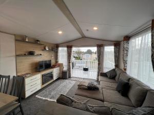 a living room with a couch and a television at The Willows in Selsey