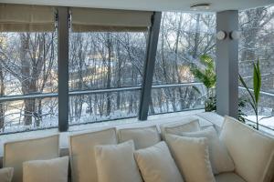un soggiorno con divano di fronte a una finestra di Boutique Penthouse a Vilnius