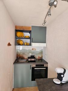 a small kitchen with a sink and a stove at Apartment Klein Matterhorn - Haus Miranda in Täsch