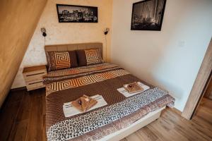 ein Schlafzimmer mit einem Bett mit zwei Handtüchern darauf in der Unterkunft Apartman Petar 26 in Divčibare