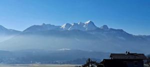 a view of a mountain range with a house at Ferienwohnung Lucia in Schiefling am See +16 photos