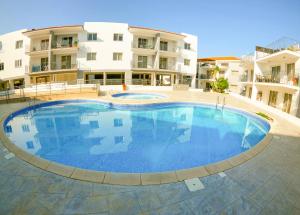 a large swimming pool in front of a building at 2 bed, Kapparis, Varvara - 2A in Paralimni