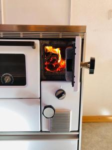 an oven with a fire inside of it at Egghof in Prato allo Stelvio