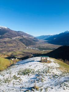 a snow covered hill with a view of a valley at Egghof in Prato allo Stelvio