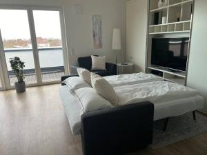 ein Wohnzimmer mit einem Bett und einem TV in der Unterkunft Tor nach Hannover in Springe