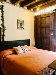 a bedroom with a large orange bed with two pillows at Tizapán 2 Beautiful apartment with patio 1BE/1BA in Mexico City