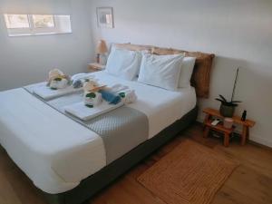 a bedroom with a bed with two stuffed animals on it at Chão do Ribeirinho 