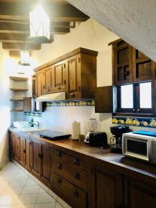 a kitchen with wooden cabinets and a microwave at Tizapán 2 Beautiful apartment with patio 1BE/1BA in Mexico City