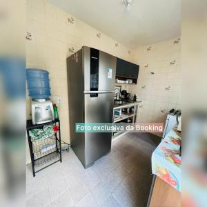 a kitchen with a stainless steel refrigerator in a room at casa de praia ibicui in Mangaratiba