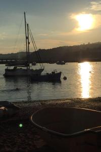 a couple of boats in the water at sunset at Luxury coastal retreat in Teignmouth