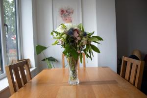 a vase of flowers sitting on top of a table at Luxury coastal retreat in Teignmouth