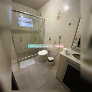 a bathroom with a shower and a toilet and a sink at casa de praia ibicui in Mangaratiba