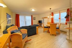 a living room with a couch and a table at Inselhaus Karlstrasse 6a Ferienwohnung 6 in Stubbenfelde