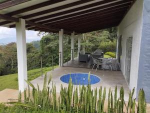 a patio of a house with a table and chairs at Villa las Águilas 1 in Borrero Ayerbe
