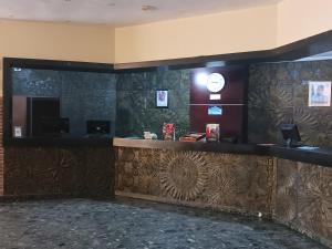 a bar in a hotel lobby with a tile wall at Equity resort hotel ijebu in Ijebu Ode