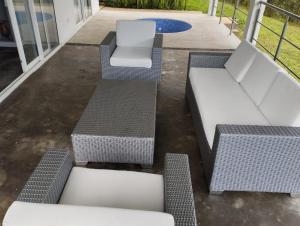 a group of chairs and tables on a patio at Villa las Águilas 1 in Borrero Ayerbe +3 photos