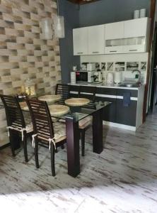 a kitchen with a table and chairs and a counter at Pod Śnieżynką in Zakopane +18 photos