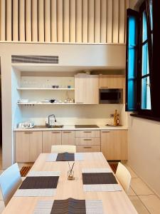 a kitchen with a wooden table and chairs at Residenza Frattini in Mantova