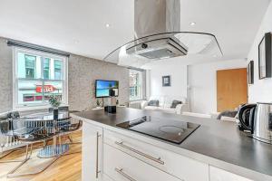 a kitchen with a counter top and a living room at 2BR flat next to London Eye on lower marsh 96A in London