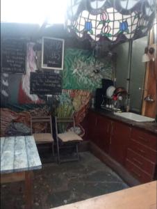 a dining room with a table and a sink at Punta del Este. Habitación privada con baño y entrada independiente. Wifi y cocina comunitaria in Punta del Este